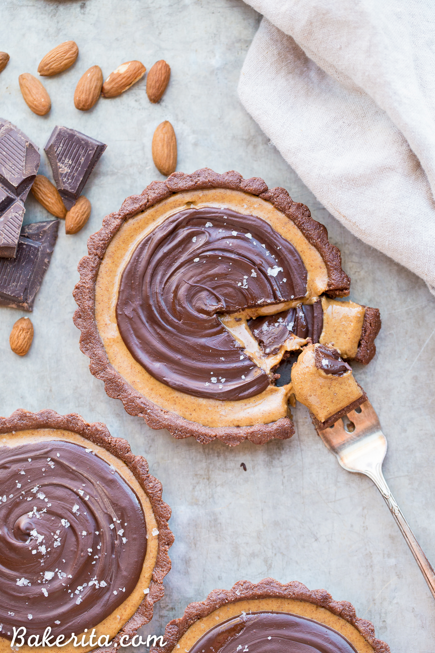 This No Bake Chocolate Almond Butter Tart tastes like a giant almond butter cup! There's no baking required and it's gluten-free, paleo, and vegan. You'll adore this melt in your mouth tart.