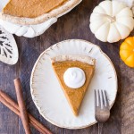 This Paleo + Vegan Pumpkin Pie is smooth, creamy, and perfectly spiced, with a flaky crust that you'd never believe is gluten-free, paleo AND vegan. This is allergy-friendly pie will be a holiday dessert staple.