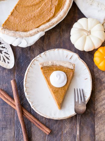 This Paleo + Vegan Pumpkin Pie is smooth, creamy, and perfectly spiced, with a flaky crust that you'd never believe is gluten-free, paleo AND vegan. This is allergy-friendly pie will be a holiday dessert staple.