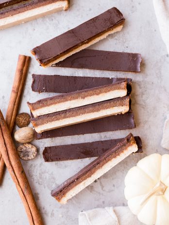 These Pumpkin Spice Twix Bars are a warm, pumpkin-spiced twist on a classic candy favorite! These copycat homemade Twix Bars are gluten-free, paleo, and vegan, and the bold pumpkin spice flavors take them out of this world.