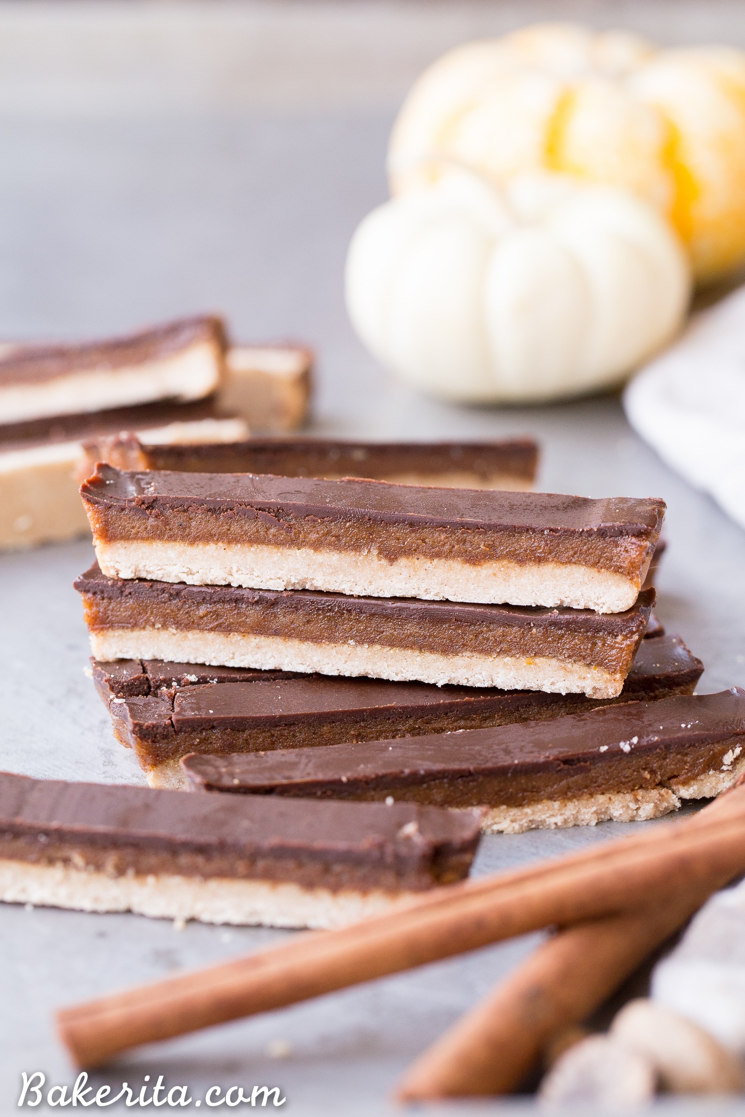 These Pumpkin Spice Twix Bars are a warm, pumpkin-spiced twist on a classic candy favorite! These copycat homemade Twix Bars are gluten-free, paleo, and vegan, and the bold pumpkin spice flavors take them out of this world.