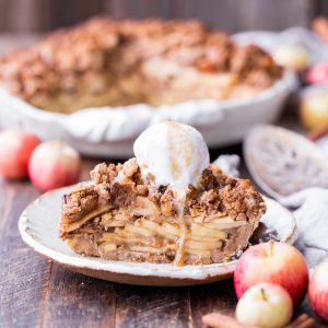 This Apple Crumble Pie is so delicious it's bound to be a holiday dessert staple! This gluten free, paleo + vegan pie is filled with soft, caramelized apples and topped with a nutty, crunchy paleo crumble topping.