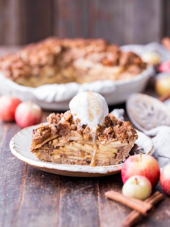 This Apple Crumble Pie is so delicious it's bound to be a holiday dessert staple! This gluten free, paleo + vegan pie is filled with soft, caramelized apples and topped with a nutty, crunchy paleo crumble topping.