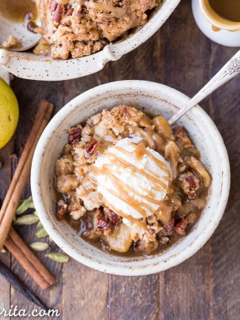 This Caramel Pear Crisp is a decadent and deliciously spiced dessert that's perfect for the holidays. The caramel pear filling is spiced with cinnamon, cardamom, cloves, and vanilla bean, and topped with a crunchy almond flour and pecan crisp topping. Don't forget to serve this gluten-free, paleo, and vegan crisp with some whipped coconut cream!