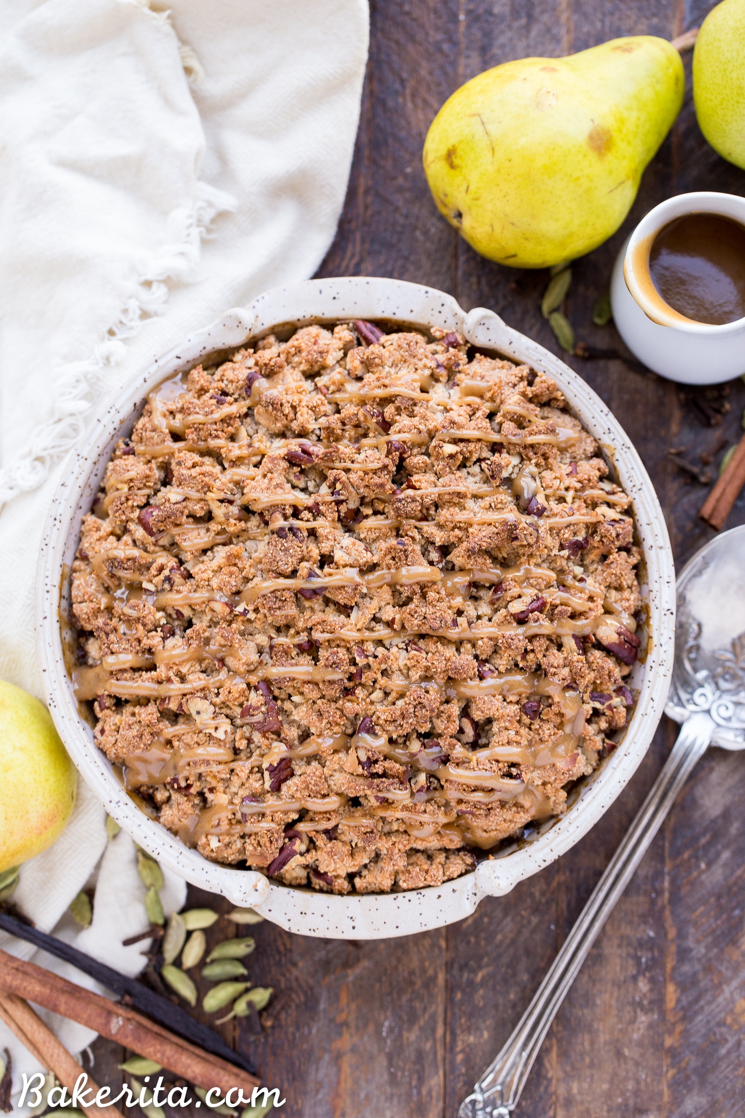 This Caramel Pear Crisp is a decadent and deliciously spiced dessert that's perfect for the holidays. The caramel pear filling is spiced with cinnamon, cardamom, cloves, and vanilla bean, and topped with a crunchy almond flour and pecan crisp topping. Don't forget to serve this gluten-free, paleo, and vegan crisp with some whipped coconut cream!