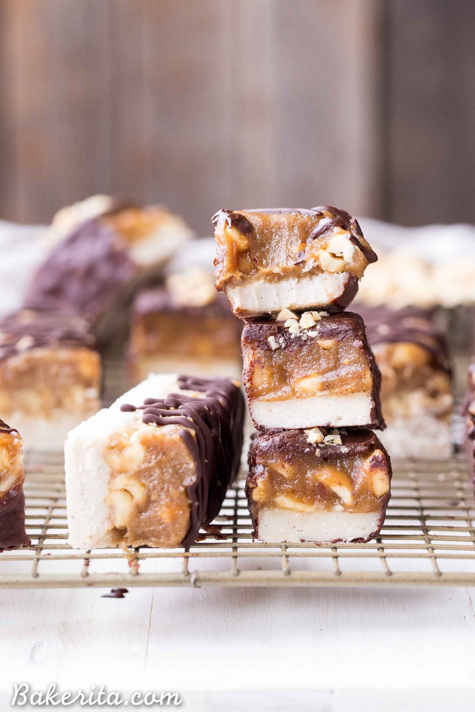 These Homemade Snickers Bars are a healthier version of the classic candy with no baking required! These gluten-free and vegan candy bars have a layer of raw nougat, topped with a peanut date caramel, all dunked in homemade chocolate.