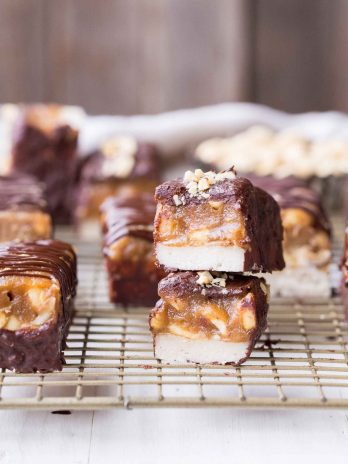 These Homemade Snickers Bars are a healthier version of the classic candy with no baking required! These gluten-free and vegan candy bars have a layer of raw nougat, topped with a peanut date caramel, all dunked in homemade chocolate.