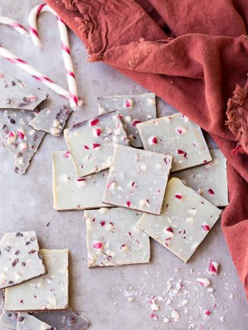 This Chocolate Peppermint Bark is a healthier twist on the holiday classic! It has a layer of dark chocolate topped with minty homemade vegan white chocolate and a sprinkling of crushed peppermint candies. You'll adore this gluten-free, paleo and vegan peppermint bark!