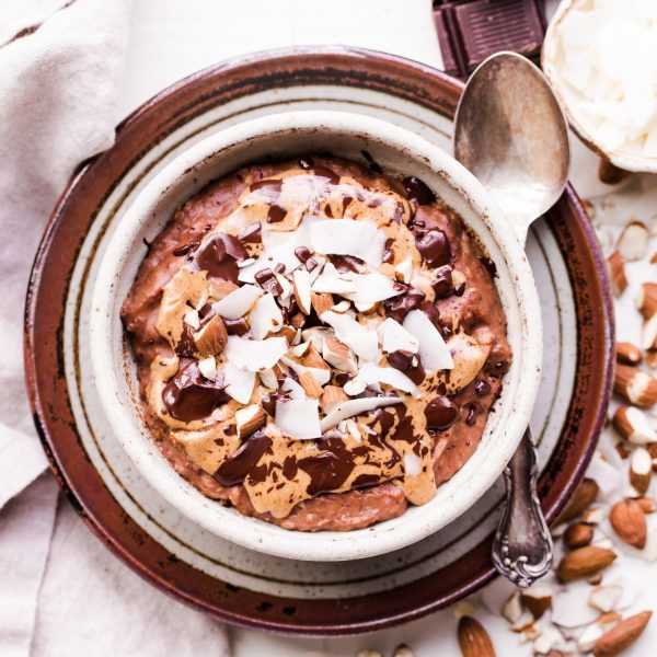 This Almond Joy Oatmeal is a creamy chocolate oatmeal that's sweetened with just a ripe banana and topped with coconut, almonds, and more chocolate! This hearty breakfast is decadent, filling, and you can enjoy it guilt free - unlike its candy bar equivalent!