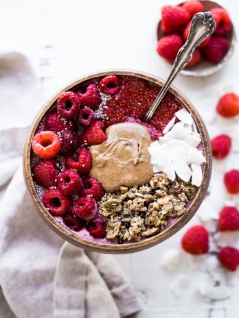 This Raspberry Almond Butter Smoothie Bowl is a creamy, sweet breakfast treat that can be made in just a few minutes and is begging to be loaded up with all of your favorite toppings! You'd never guess there was a hidden veggie in there, too.