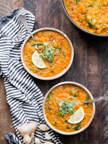 Two bowls of Vegan Red Lentil Soup topped with microgreens and a lemon wedge! The perfect healthy vegan dinner.