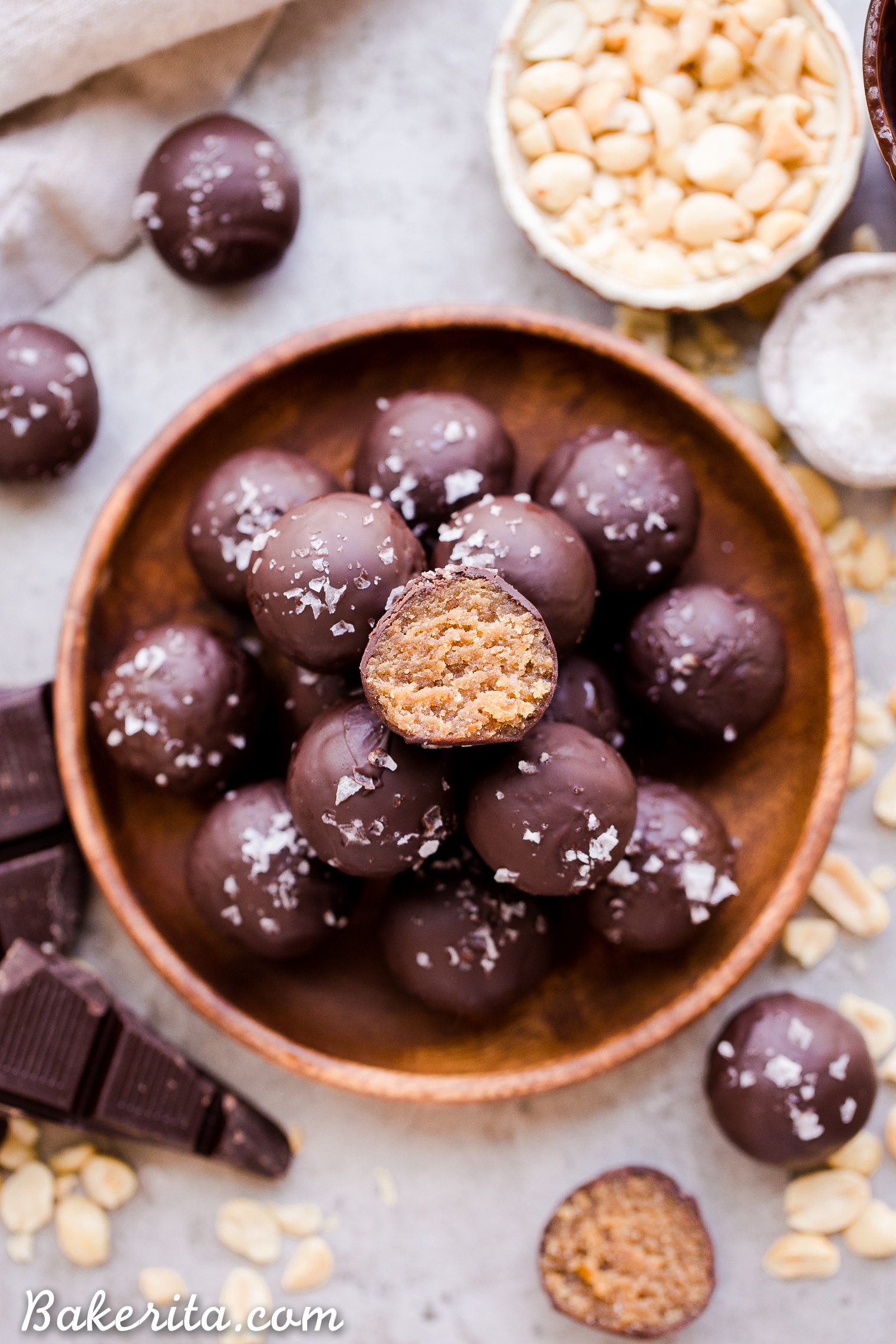 These Chocolate Peanut Butter Truffles are decadent, delicious, and made with just FOUR super simple + clean ingredients. They're gluten-free, vegan and sweetened with dates - they can also easily be made paleo by using a different nut butter! These truffles are sure to satisfy your chocolate peanut butter candy cravings.
