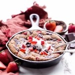 This Strawberry Chocolate Chunk Skillet Cookie is gooey in the middle, with crispy edges and all the flavors you love in a chocolate covered strawberry! This gluten-free, paleo and vegan skillet cookie will satisfy all your cravings - the fresh strawberries are the perfect fruity addition to this rich, chocolatey treat!