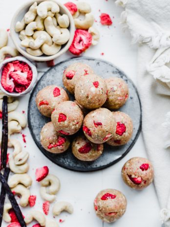 These Strawberry Vanilla Bean Energy Balls are an easy, no-bake snack that tastes like strawberry shortcake! With a base of raw cashews, they're buttery and deliciously flavored with vanilla and strawberries. They're gluten-free, paleo, and vegan, and perfect for bringing on the go.