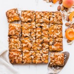 In these Apricot Frangipane Bars, apricots and almonds come together in the most delightful way - the shortbread crust is topped with an almond frangipane filling and topped with fresh, juicy apricots. These gluten-free, paleo, and vegan bars are irresistibly delicious. You can customize them with your favorite stone fruit, too!