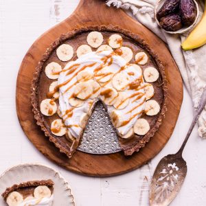 This No Bake Banana Caramel Tart is similar to a classic Banoffee pie, but there's no baking necessary and it's sweetened entirely with dates! This healthy twist on a classic is sweet and scrumptious with a date caramel filling and coconut whipped cream on top. It's gluten-free, paleo, and vegan.