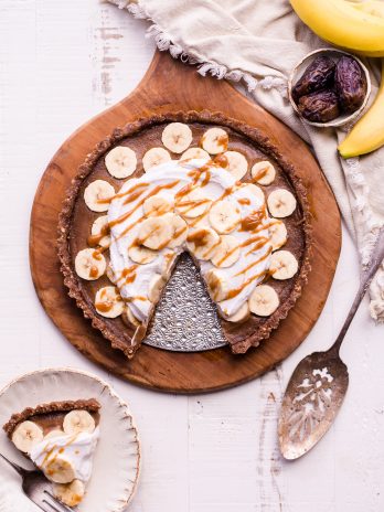 This No Bake Banana Caramel Tart is similar to a classic Banoffee pie, but there's no baking necessary and it's sweetened entirely with dates! This healthy twist on a classic is sweet and scrumptious with a date caramel filling and coconut whipped cream on top. It's gluten-free, paleo, and vegan.