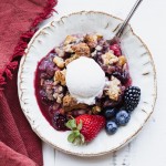 This Mixed Berry Crisp uses a mix of your favorite berries and is topped with a crunchy oatmeal crisp topping. This flavorful dessert is gluten-free, vegan, and best served with some dairy-free ice cream or coconut whipped cream!