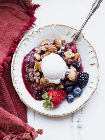 This Mixed Berry Crisp uses a mix of your favorite berries and is topped with a crunchy oatmeal crisp topping. This flavorful dessert is gluten-free, vegan, and best served with some dairy-free ice cream or coconut whipped cream!