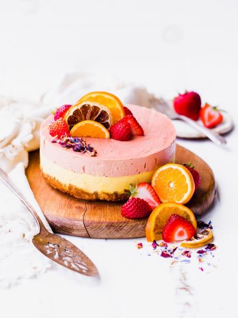 This Strawberry Orange Cheesecake with Coconut Crust is not just beautiful, but it's bright in flavor and absolutely delicious! The lemony coconut macaroon crust is perfect with the strawberry and orange flavors. You're going to adore this gluten-free, paleo and vegan cheesecake. 