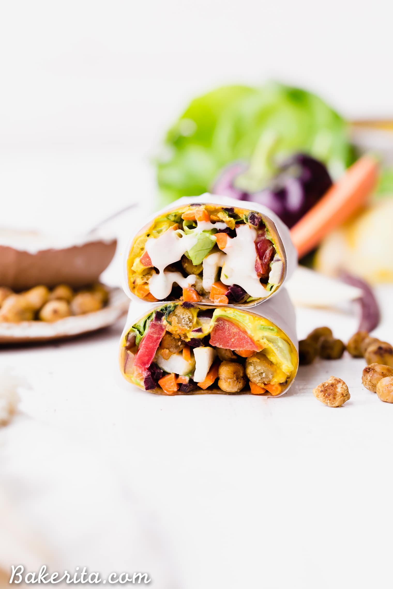 These Roasted Chickpea Veggie Wraps are a delicious gluten-free and vegan lunch or dinner that you can make ahead of time. They have a wonderful Turmeric Hummus spread inside and a Tahini Dressing/Dipping Sauce to serve with!