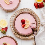 These No Bake Strawberry Lemonade Tarts have a raw "graham cracker" style crust filled with a super refreshing strawberry lemonade filling. These are SO good frozen on a hot day and they're gluten-free, paleo and vegan.