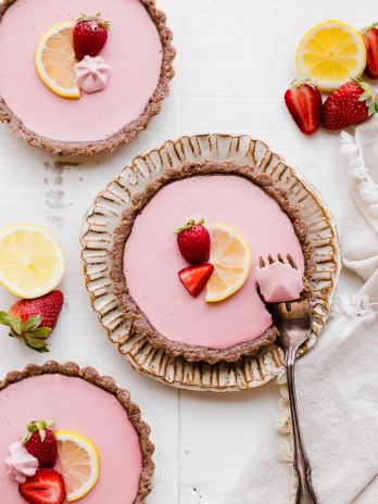 These No Bake Strawberry Lemonade Tarts have a raw "graham cracker" style crust filled with a super refreshing strawberry lemonade filling. These are SO good frozen on a hot day and they're gluten-free, paleo and vegan.