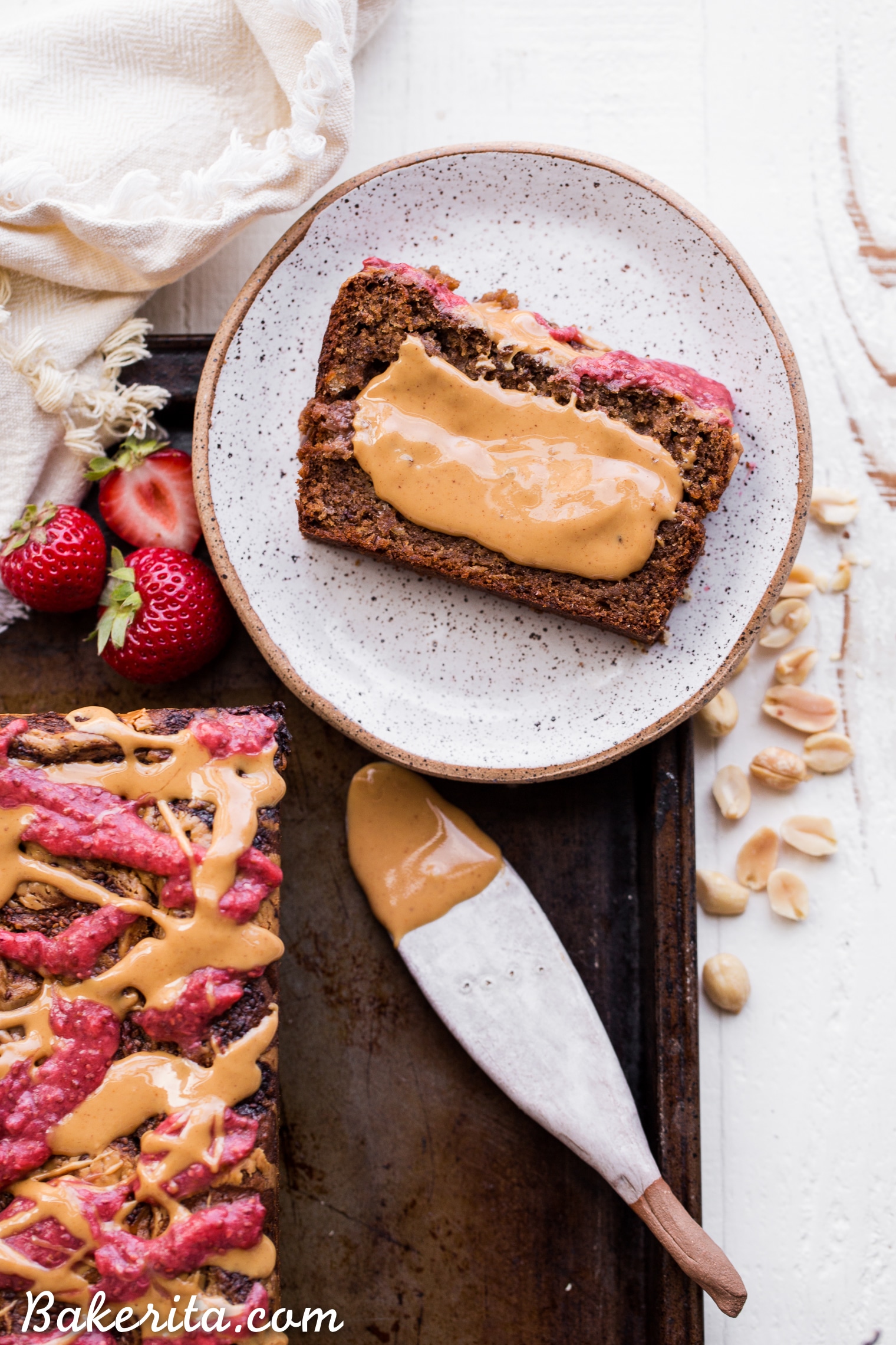 This Peanut Butter & Jelly Banana Bread will remind you of a PB&J sandwich, but in soft & sweet banana bread form. This recipe is gluten-free, vegan, and layered with homemade strawberry chia jam and creamy peanut butter.