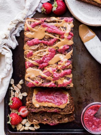 This Peanut Butter & Jelly Banana Bread will remind you of a PB&J sandwich, but in soft & sweet banana bread form. This recipe is gluten-free, vegan, and layered with homemade strawberry chia jam and creamy peanut butter.