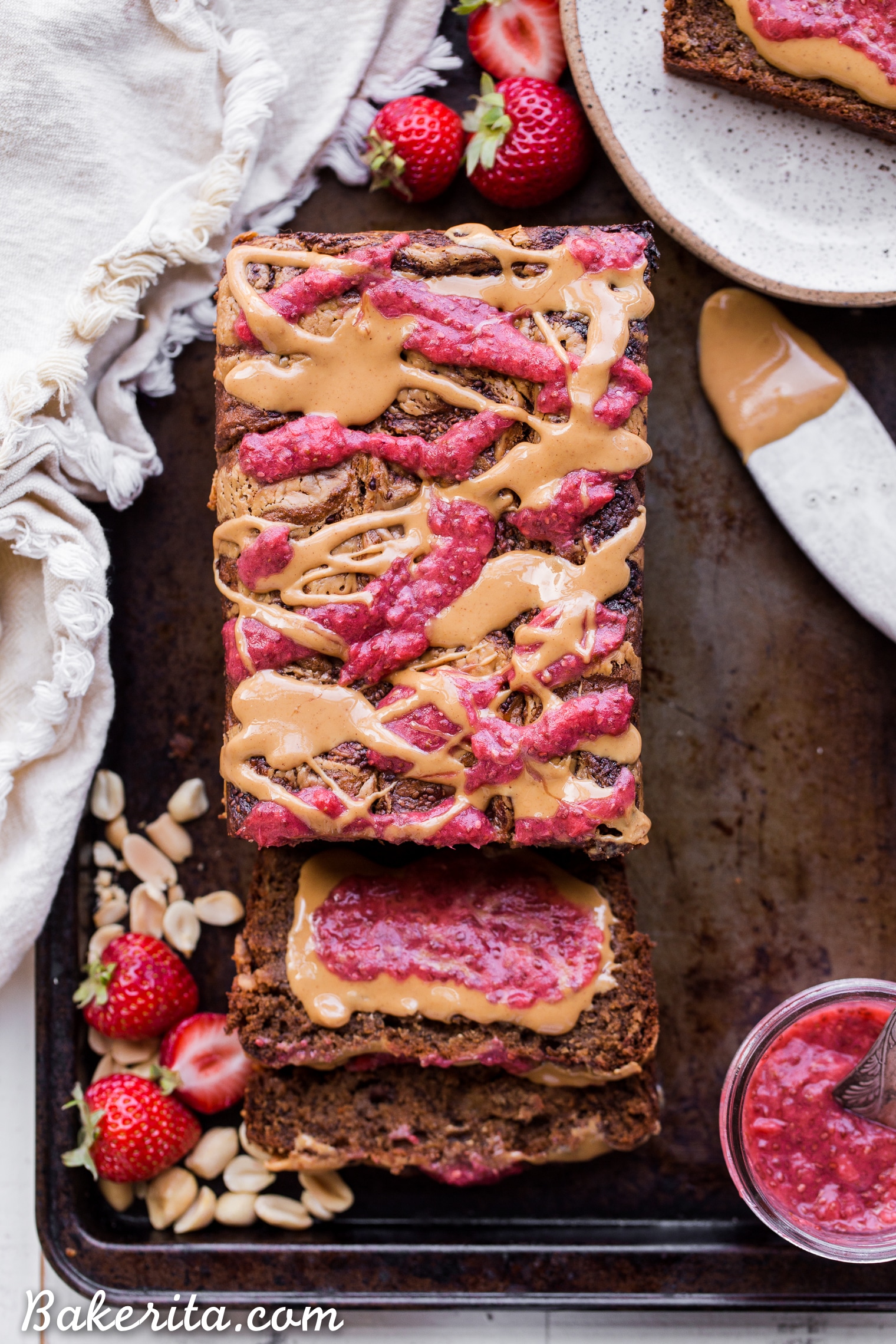 This Peanut Butter & Jelly Banana Bread will remind you of a PB&J sandwich, but in soft & sweet banana bread form. This recipe is gluten-free, vegan, and layered with homemade strawberry chia jam and creamy peanut butter.