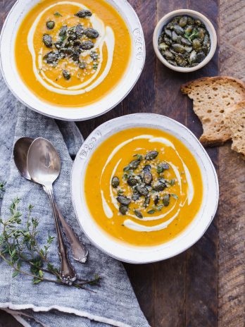 This Butternut Squash Soup is smooth, brightly flavored, and swirled with an easy cashew cream. It's topped off with crunchy spiced pumpkin seeds. This paleo and vegan soup is perfect for chilly days and best served with some crusty gluten-free bread!