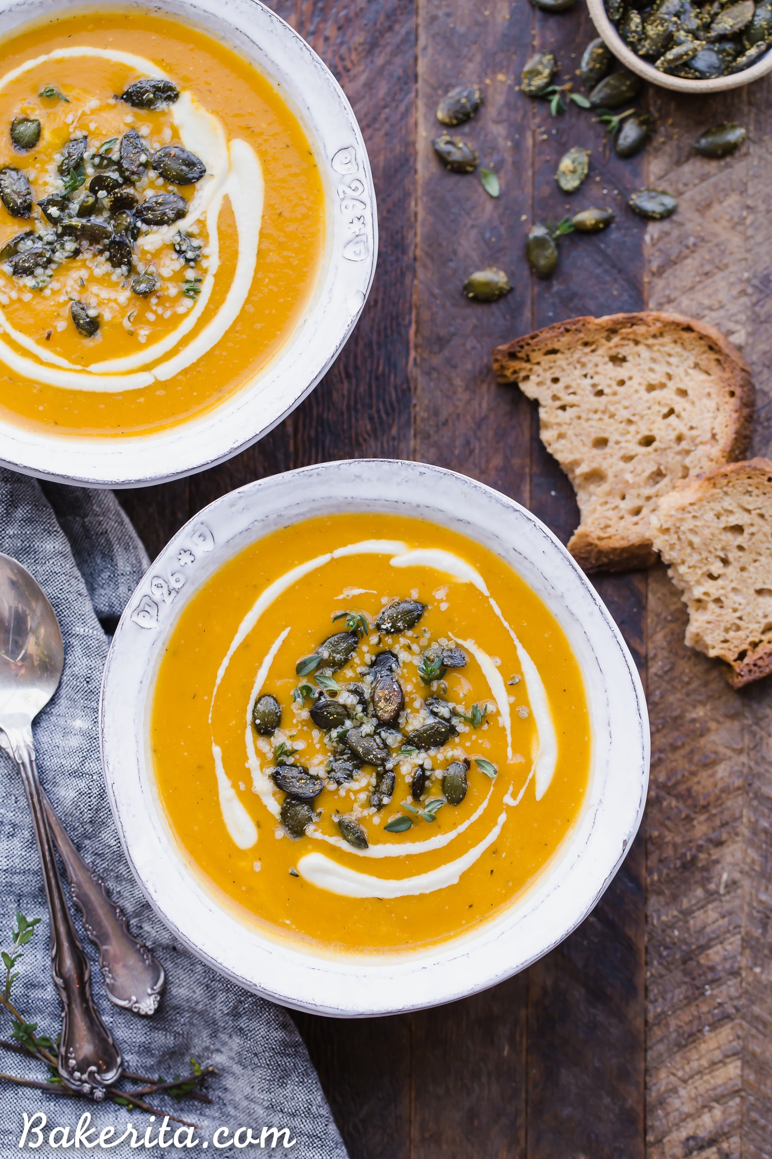 This Butternut Squash Soup is smooth, brightly flavored, and swirled with an easy cashew cream. It's topped off with crunchy spiced pumpkin seeds. This paleo and vegan soup is perfect for chilly days and best served with some crusty gluten-free bread!