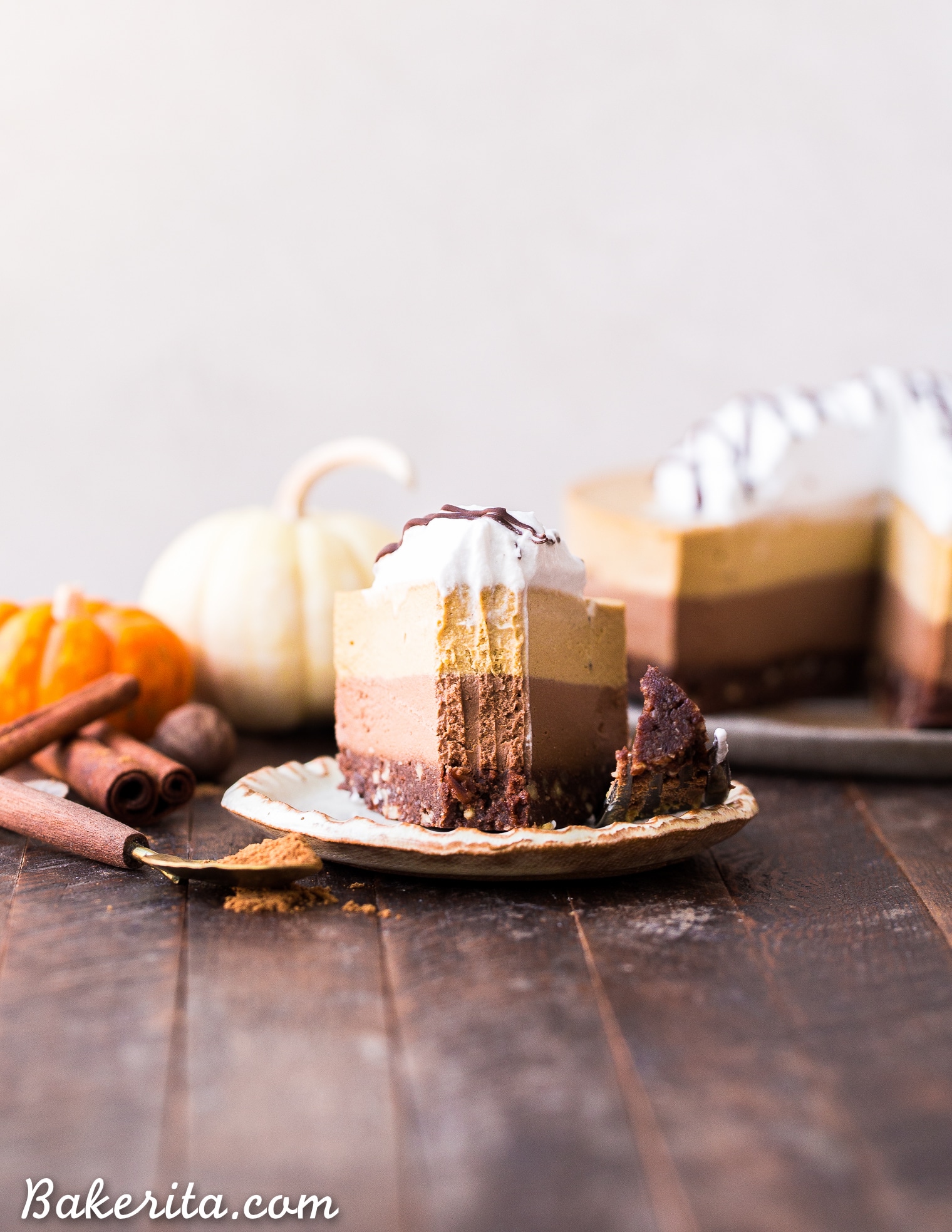 This No-Bake Vegan Chocolate Pumpkin Cheesecake has layers of chocolate and pumpkin spice cashew-based cheesecake, on top of a chocolate date crust. This make-ahead raw dessert is perfect for the holidays.