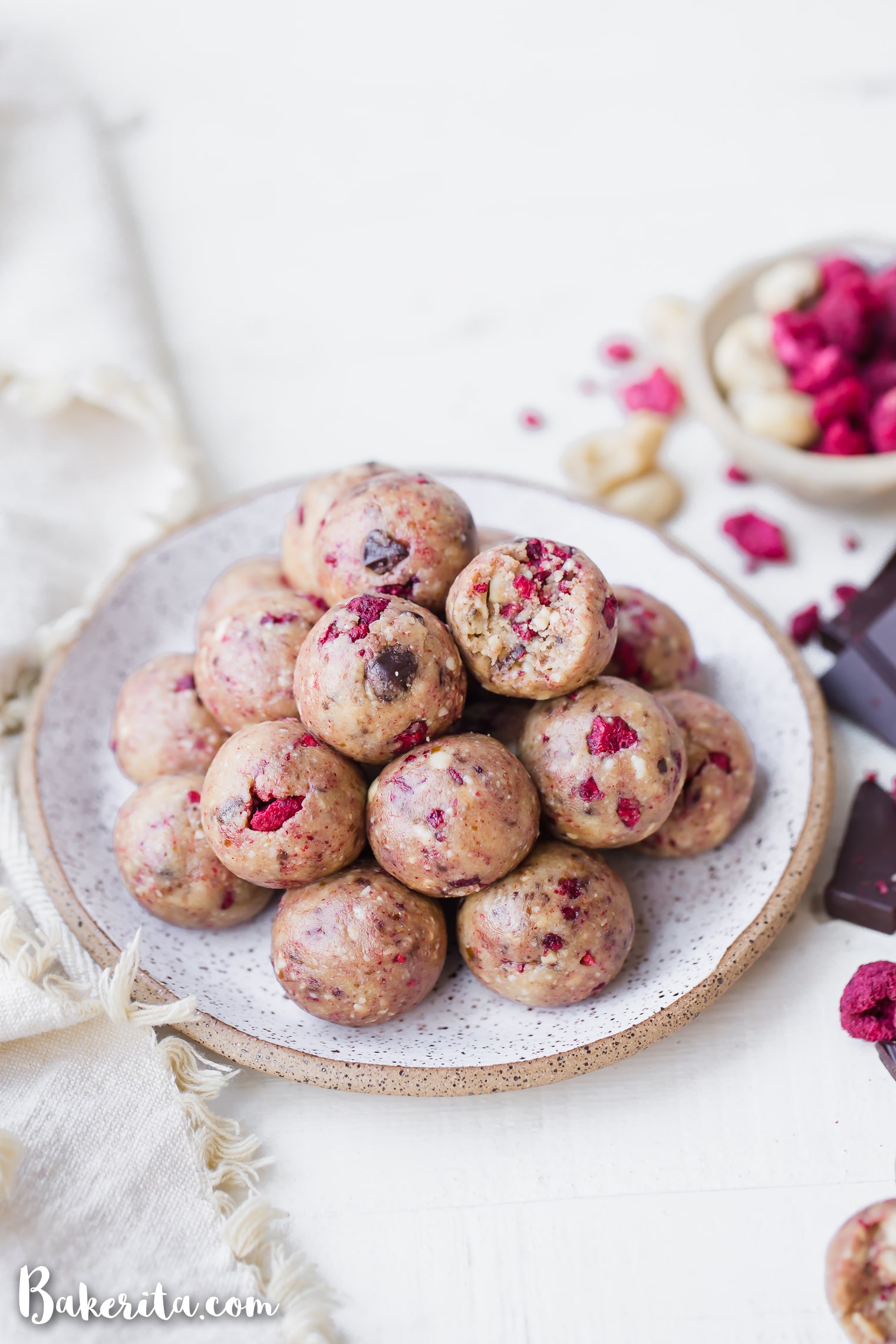These Raspberry Dark Chocolate Energy Bites are deliciously filling and laced with the bold flavor of raspberries and shards of dark chocolate. They make the perfect gluten-free, paleo, and vegan snack or treat.