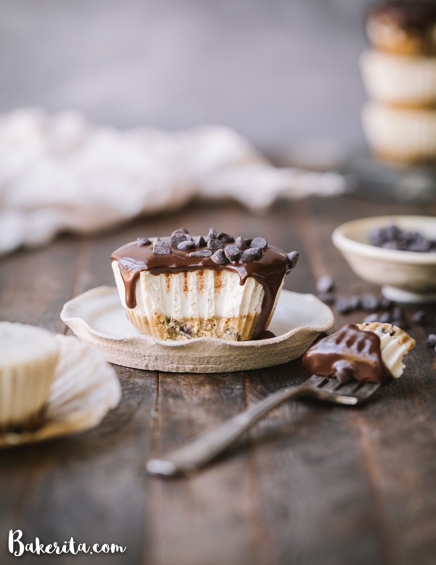 In these No-Bake Vegan Chocolate Chip Cookie Dough Cheesecakes, vanilla cashew cheesecake tops a gluten-free & paleo chocolate chip cookie dough crust. Topped with dark chocolate ganache, these mini cheesecakes make a decadent treat you'll make again and again!