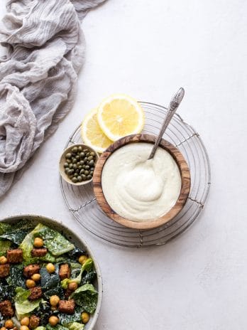 We make this creamy Vegan Caesar Dressing without any dairy, yet it maintains the creaminess you love from a classic Caesar dressing thanks to soaked cashews. The dressing is briny, salty, tart, and so delicious as a salad dressing, a dip, or spread on sandwiches and wraps.