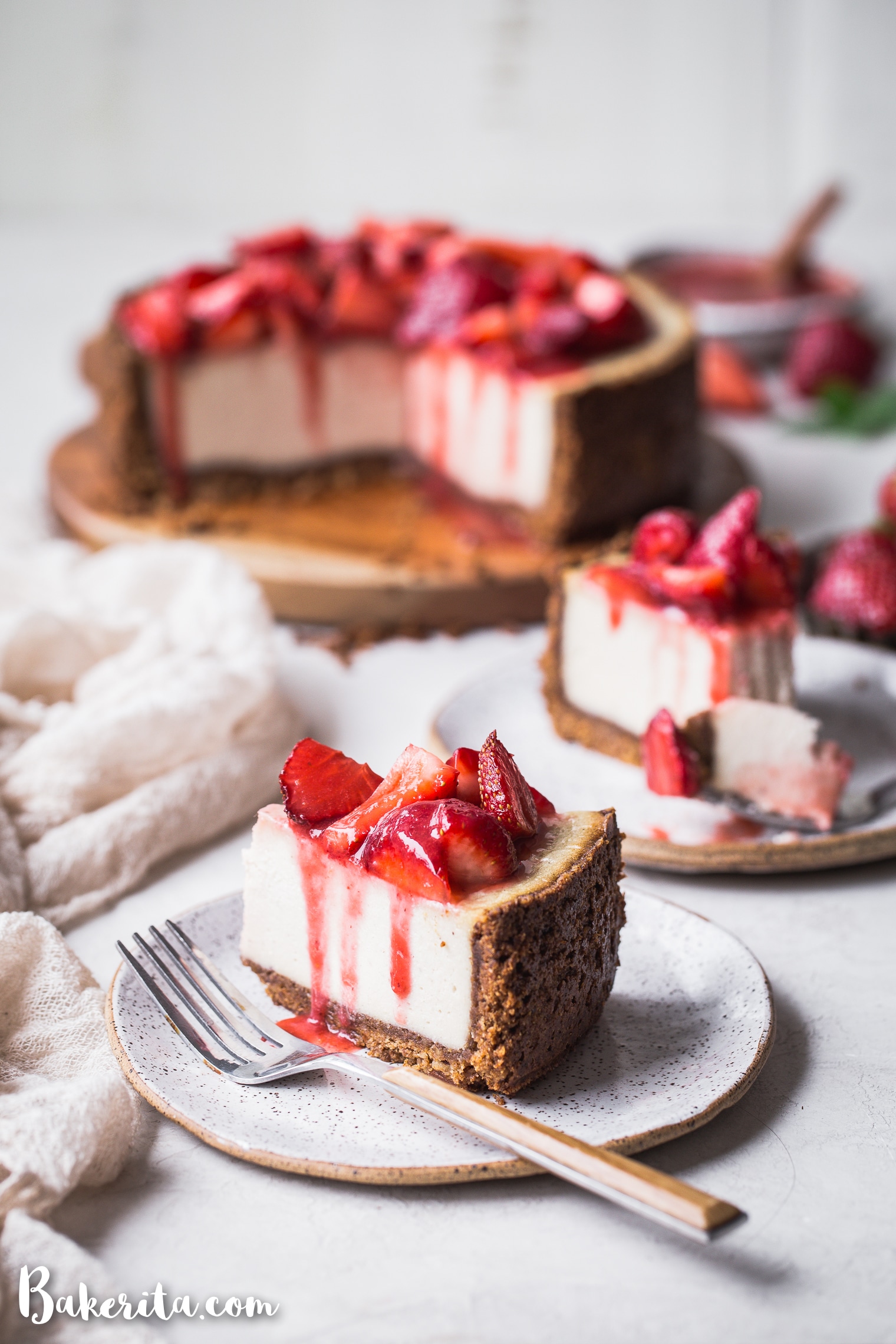 In this Baked Vegan Cheesecake, a gluten-free and paleo graham cracker-style crust encases a sweet and creamy vanilla cheesecake filling. Coconut yogurt and cashews create the perfect texture to mimic a classic cheesecake.