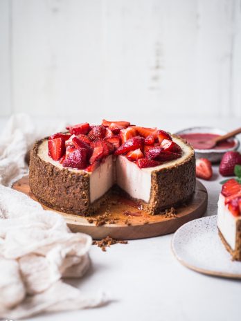 In this Baked Vegan Cheesecake, a gluten-free and paleo graham cracker-style crust encases a sweet and creamy vanilla cheesecake filling. Coconut yogurt and cashews create the perfect texture to mimic a classic cheesecake.