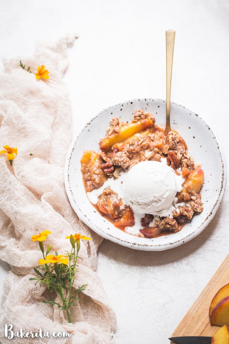 This Gluten-Free & Vegan Peach Crisp recipe is a summer staple! Scented with cinnamon and baked until bubbly, the fresh peaches are perfectly complemented by the pecan crisp topping. Top with a scoop of ice cream for the perfect dessert!
