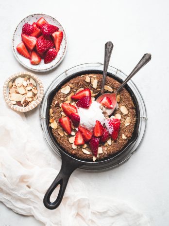 This Gluten-Free & Vegan Sugar Cookie Skillet will make your mouth water! You'll love this easy sugar cookie recipe - it's gluten-free, vegan, paleo, and topped with sliced almonds and raw turbinado sugar.