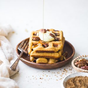 These Gluten-Free Vegan Pumpkin Waffles are easy to make with a crispy exterior and a warm, fluffy inside. They're freezer-friendly too, making them perfect for meal prep!