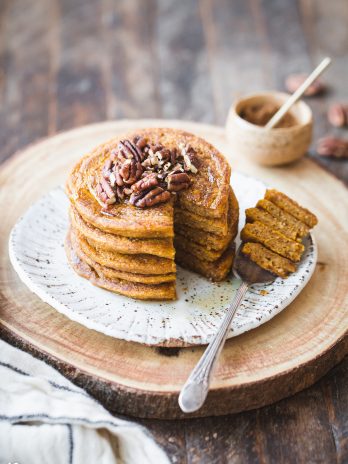 These Gluten-Free Vegan Pumpkin Pancakes tastes like fall thanks to the warm pumpkin spices and maple syrup! They're easy-to-make, light, fluffy, and absolutely delicious. 