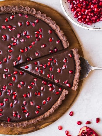 This No-Bake Chocolate Pomegranate Tart is made with 8 simple ingredients and is perfect for holiday entertaining! No baking required for this gluten-free, paleo, and vegan tart.
