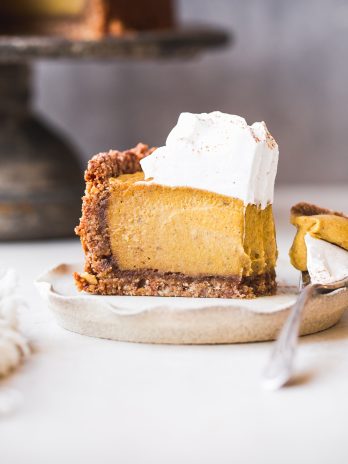 This Baked Vegan Pumpkin Cheesecake will wow you with its rich texture, spices, and graham cracker style crust. It's the perfect vegan Thanksgiving dessert.