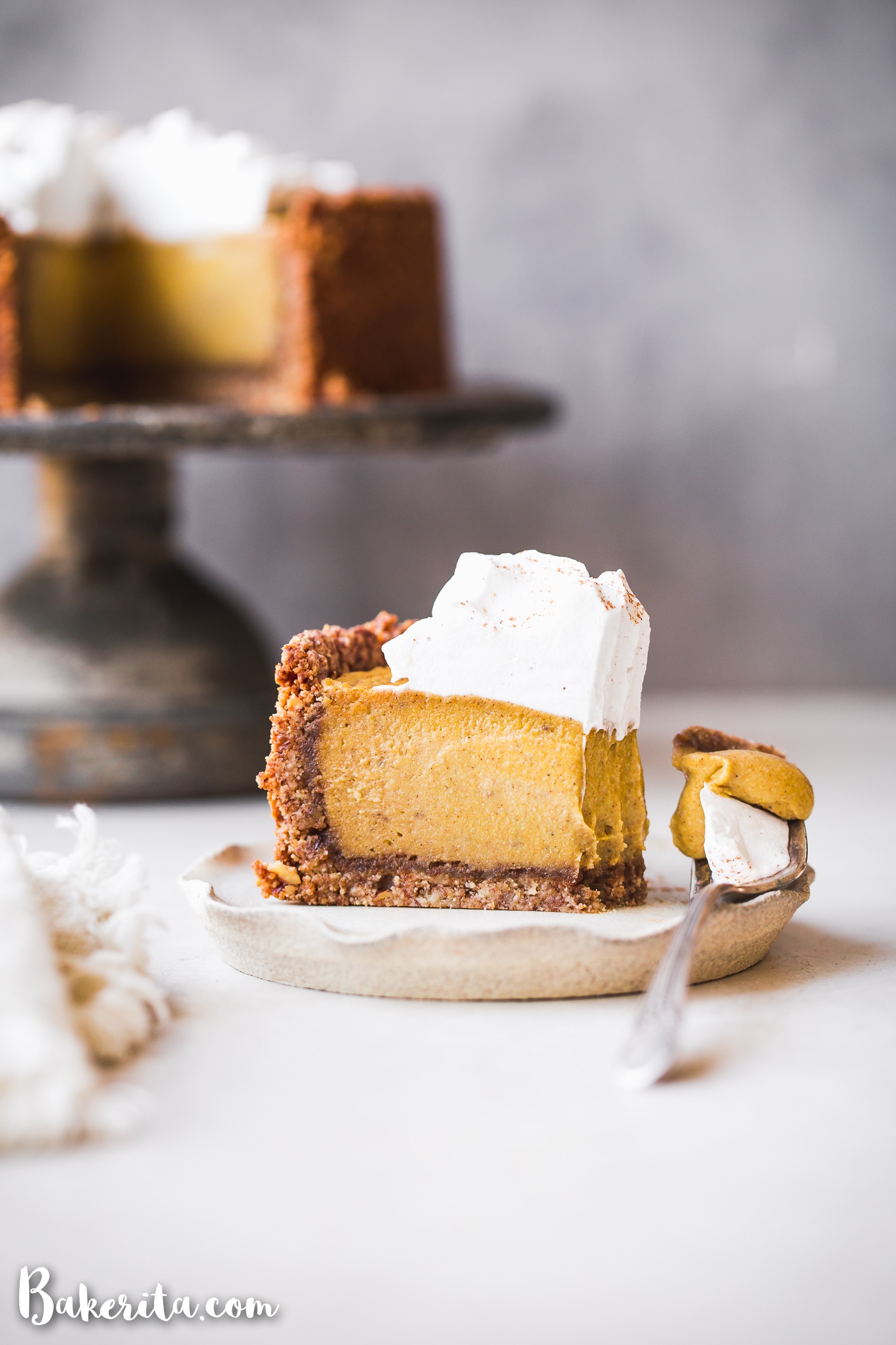 This Baked Vegan Pumpkin Cheesecake will wow you with its rich texture, spices, and graham cracker style crust. It's the perfect vegan Thanksgiving dessert.