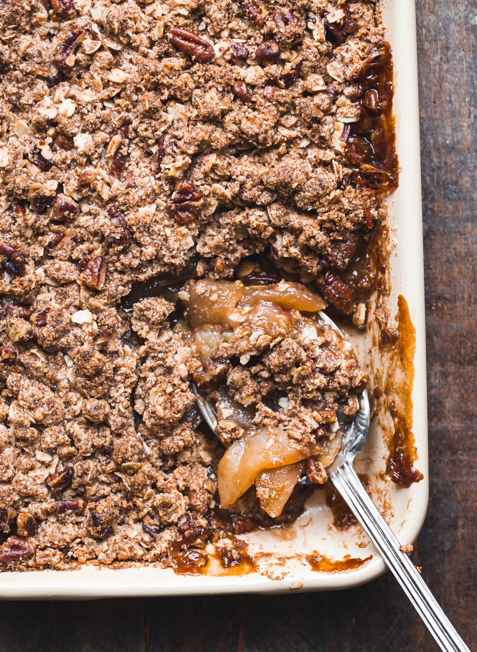 This Gluten-Free Vegan Apple Crisp will make you want seconds! With a luscious caramel apple filling and oatmeal crumble topping, this vegan holiday dessert is irresistible.