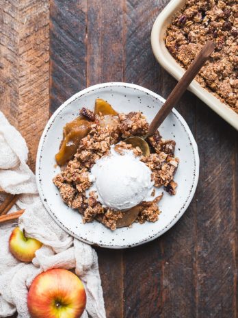 This Gluten-Free Vegan Apple Crisp will have you serving yourself seconds! With a luscious caramel apple filling and oatmeal crumble topping, this vegan holiday dessert is irresistible.
