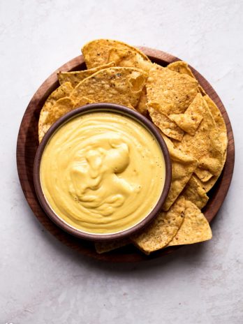 This Vegan Cheese Sauce recipe is easy to make and tastes good on just about everything! It's made with vegetables and cashews for an oil-free, dairy-free cheese sauce. You'll love it with pasta or vegetables, on nachos, and taco bowls, or used as a dip with chips or veggies.