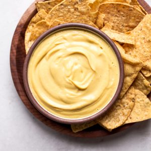 This Vegan Cheese Sauce recipe is easy to make and tastes good on just about everything! It's made with vegetables and cashews for an oil-free, dairy-free cheese sauce. You'll love it with pasta or vegetables, on nachos, and taco bowls, or used as a dip with chips or veggies.