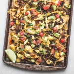 These are the BEST Vegan Nachos I've ever had! They're loaded with sauteed vegetables, vegan taco meat, pico de gallo, avocado, cilantro, and topped with a ton of vegan cheese sauce. They're the perfect cheesy snack for game day.